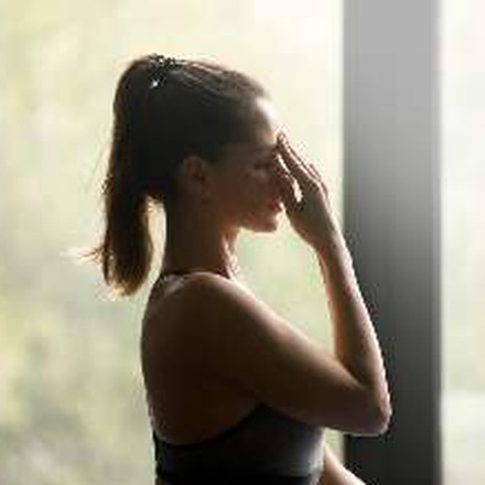 Woman breathing deeply by a window