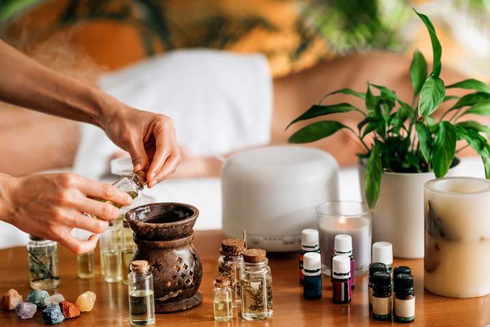 Essential oils, a diffuser and a towel on a table