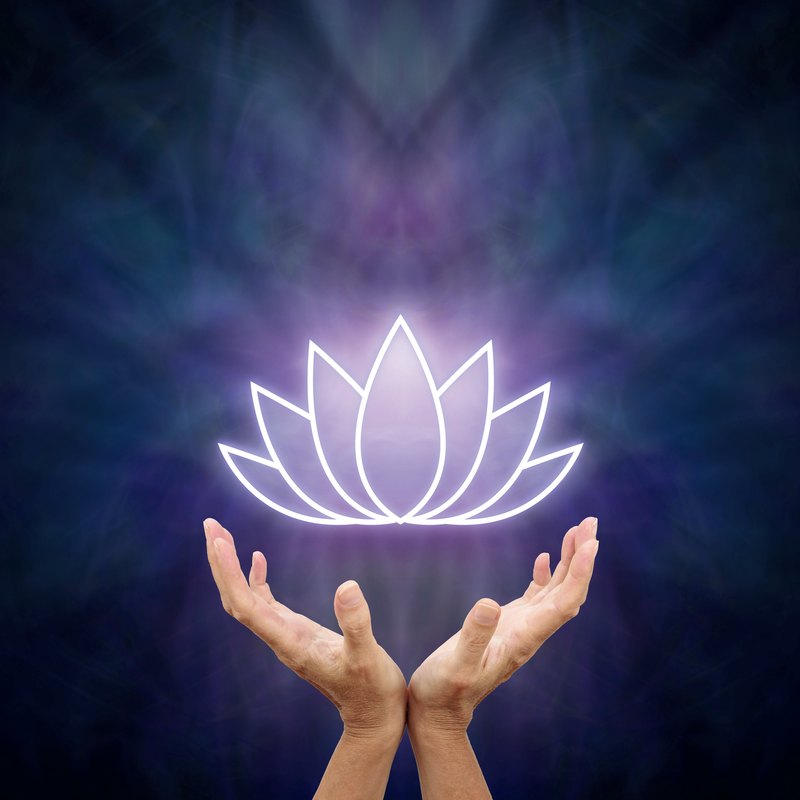 Hands holding a glowing lotus