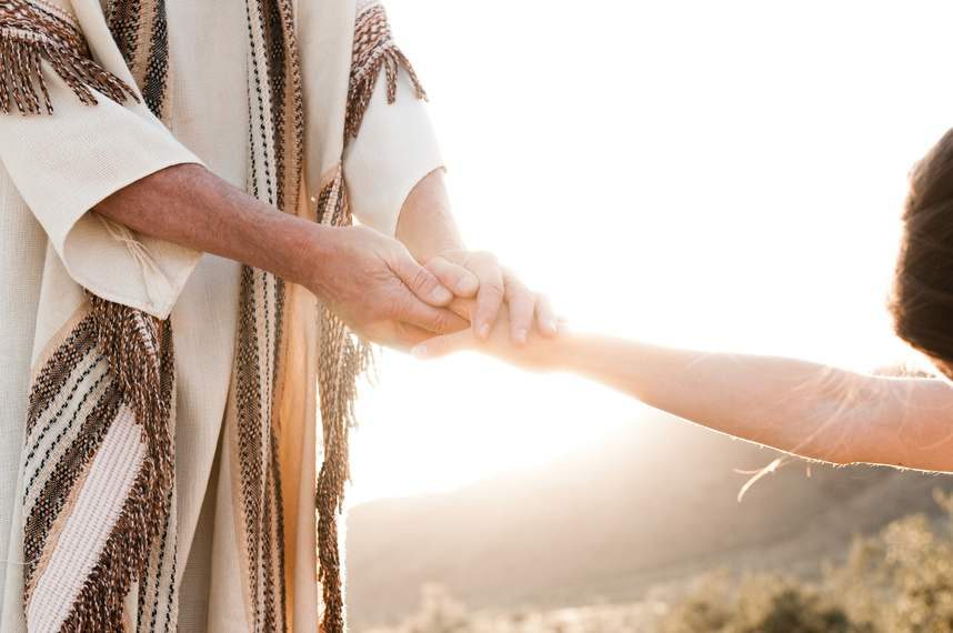 Two people holding hands