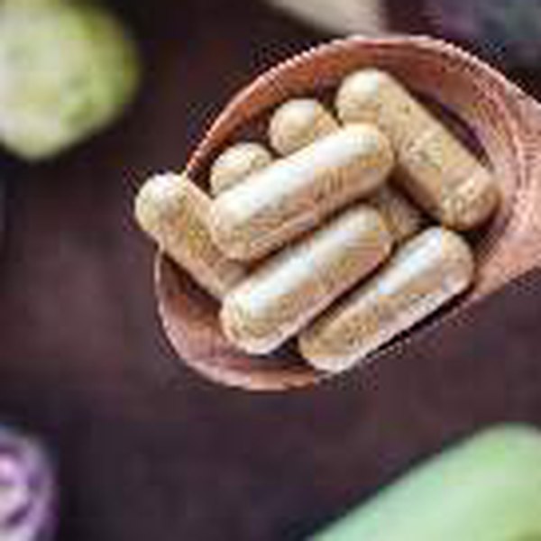 Capsules in a wooden spoon