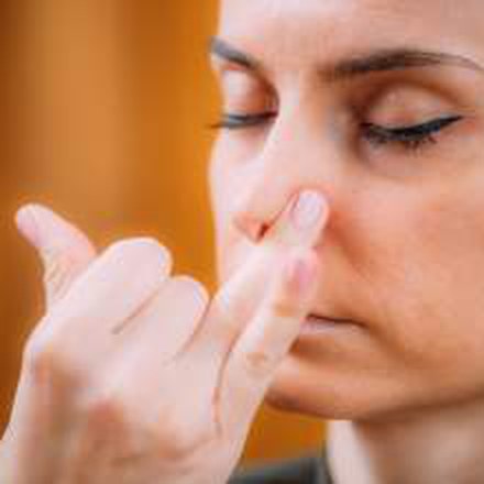 Woman inhaling slowly through the nose